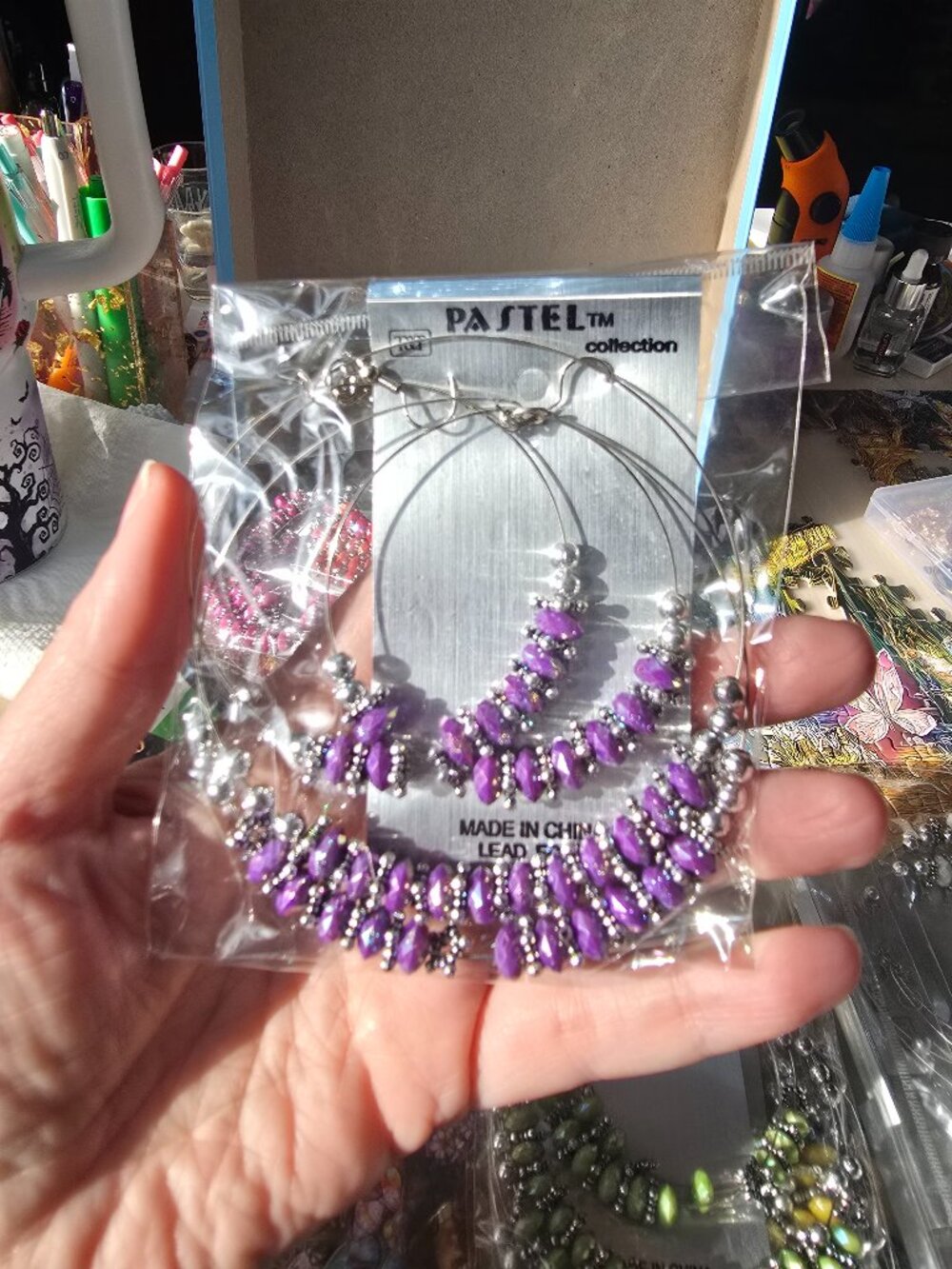 Pastel Collection silver-tone hoop earrings featuring purple and silver beads.